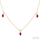 1/8 ctw Round Cut Diamonds and 5X3MM Oval Shape Ruby Precious Station Necklace in 10K Yellow Gold